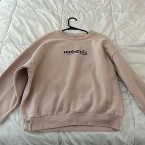 Pink, medium crew neck with “authentic” written on the front. Very soft inside.